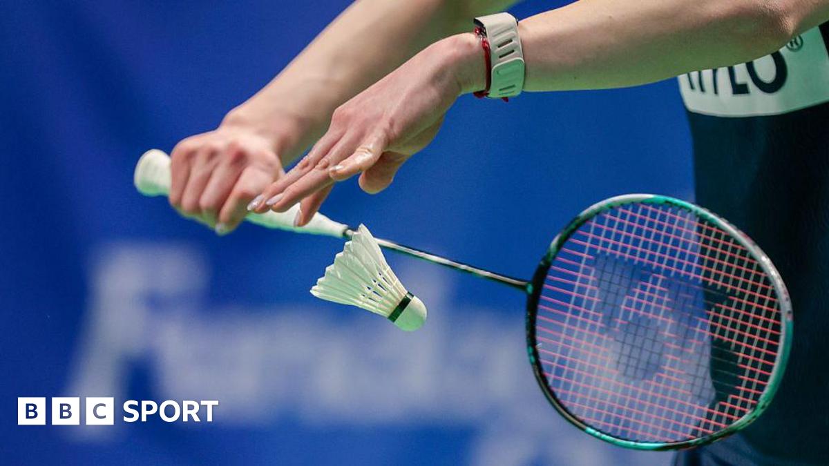 Badminton player serves a shuttlecock