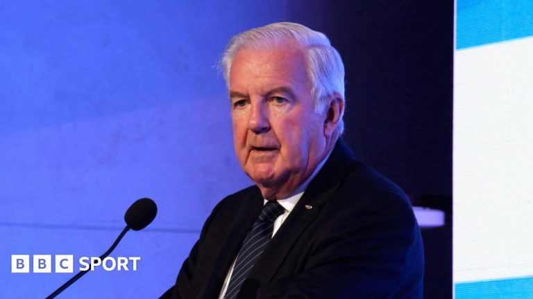Sir Craig Reedie speaking at a podium in 2018